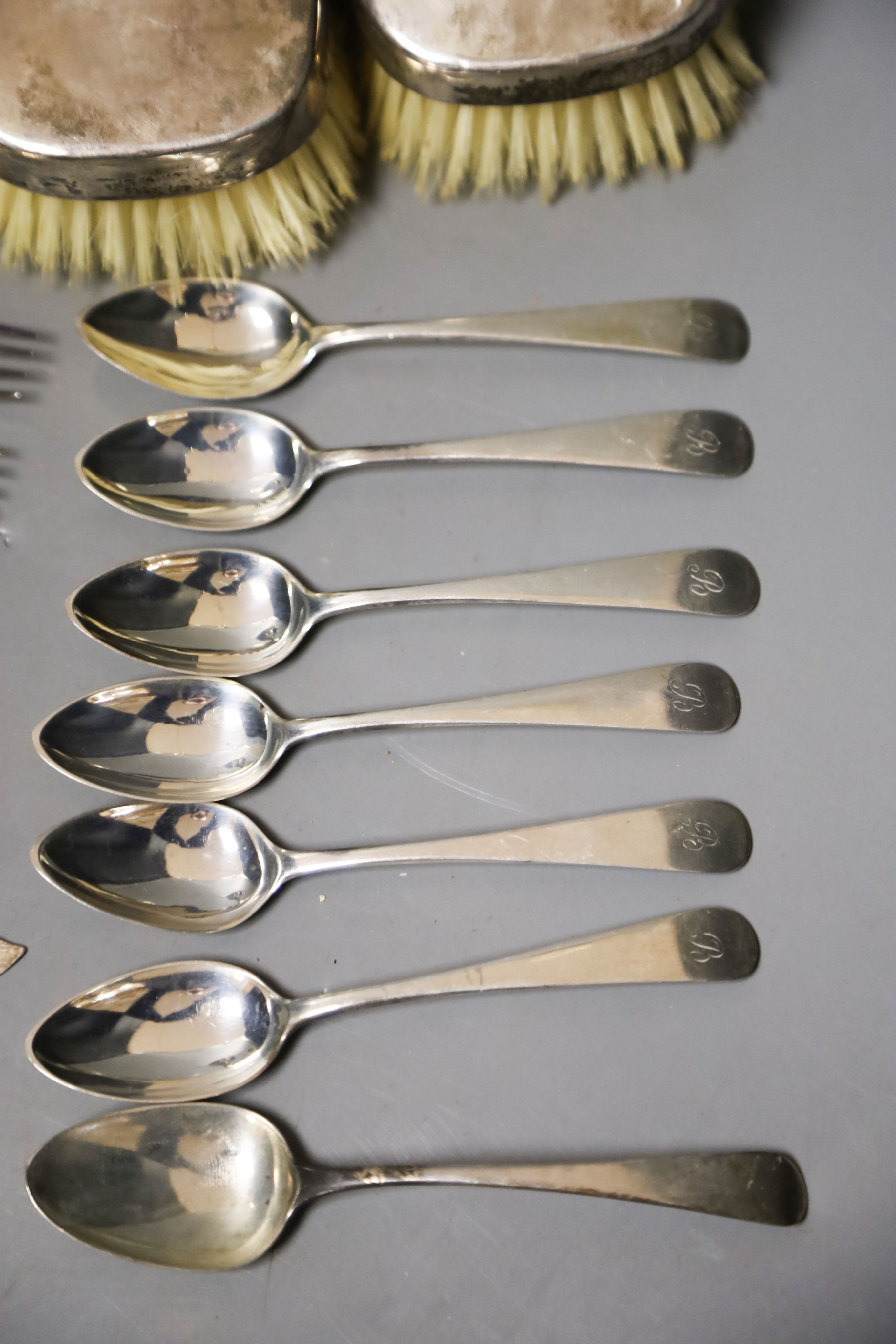 A pair of silver mounted clothes brushes, a silver two handled trophy cup and sundry flatware.